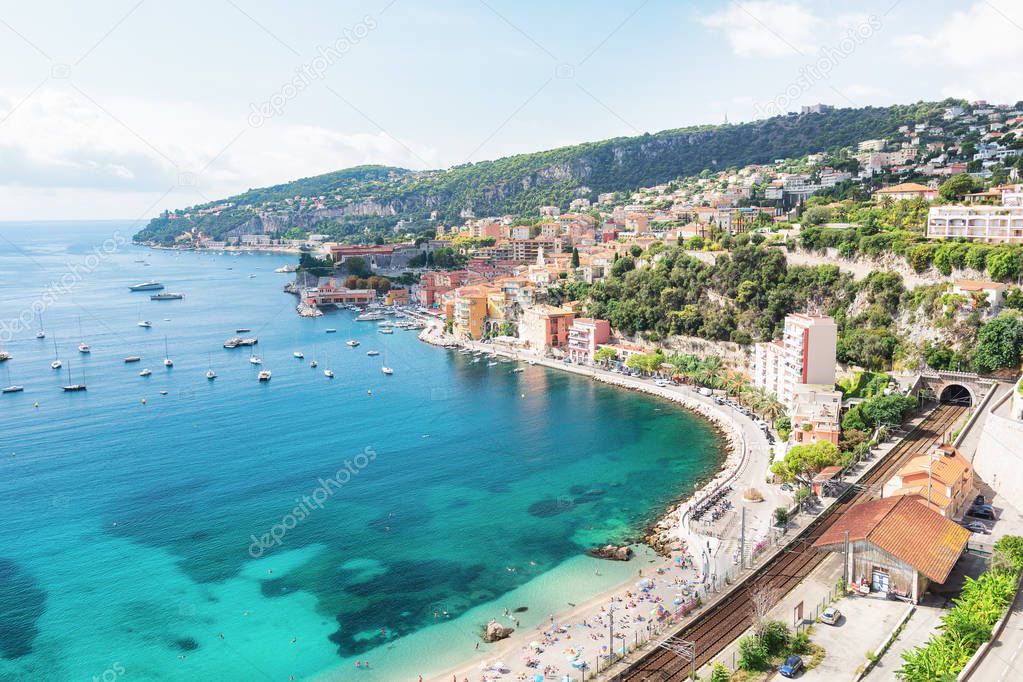 Bathers enjoy at the beach of the beautiful bay of Villefranche-sur-Mer on the Cote D'Azur in France