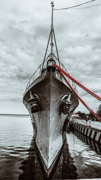 The prow of a warship and red rope.