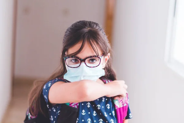 back to school with surgical masks for protection against the coronavirus covid-19