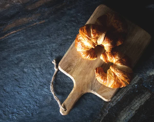 灰色深色背景下新鲜出炉的羊角面包 法国菜 — 图库照片