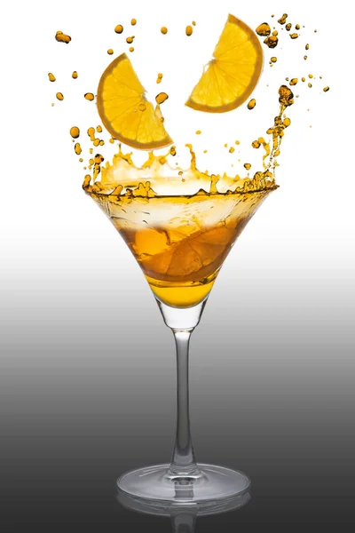 splash of orange cocktail on white background