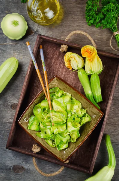 Zucchini ribbon salad with parsley, dill and garlic in marinade — Stock Photo, Image