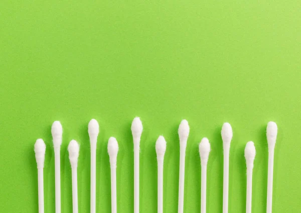 The symbol of the green grass is made of cotton sticks on a green background — Stock Photo, Image