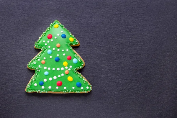 Handmade cookie like a decorated christmas tree on black with copy space — Stock Photo, Image