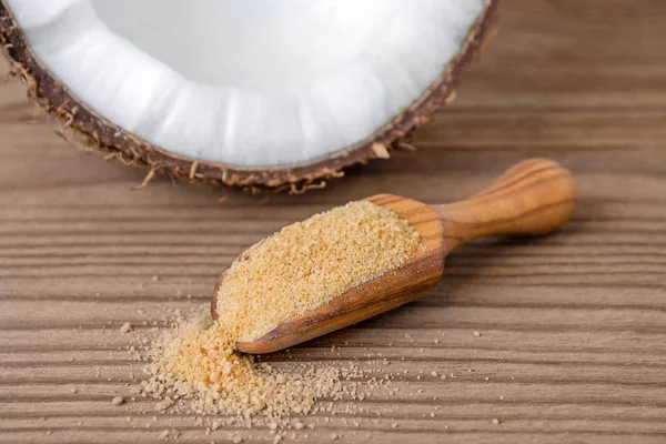 Bio-Kokoszucker in einer Kugel auf braunem Holzhintergrund — Stockfoto