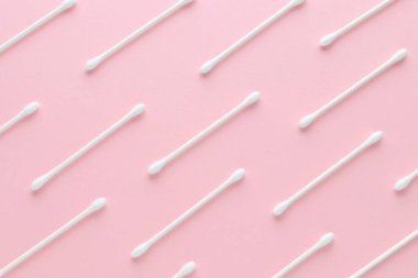 white cotton paper sticks on pink background