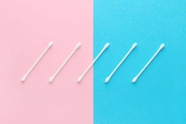 White cotton swabs on pink and blue background — Stock Photo, Image