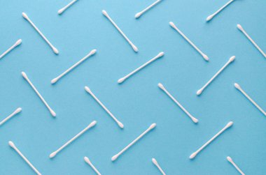 white cotton swabs on blue background, abstract pattern