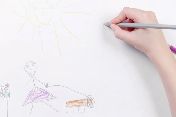 child drawing a woman with dog and sun with color pensils