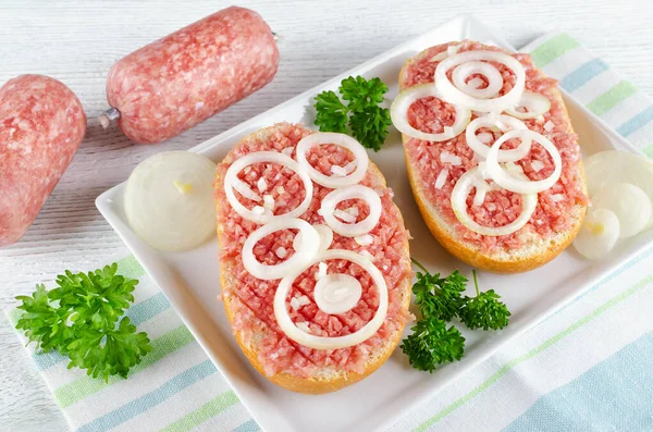 german food mett ground pork, bun and raw meat with onion and parsley