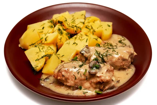 stewed potatoes with meat and mushrooms on a white background