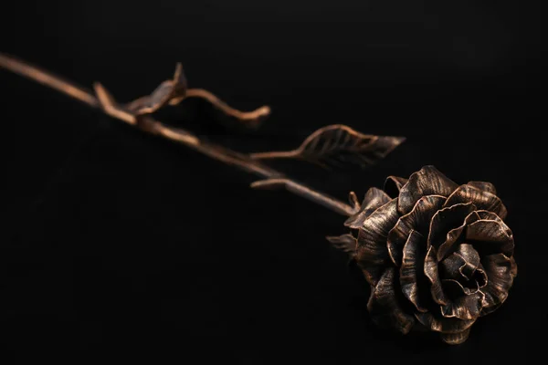 Růže Květ Stonek Bronzové Barvě Vyrobené Kovu Leží Povrchu Černé — Stock fotografie