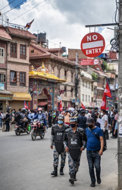 June 14, 2020, Kathmandu, Nepal. AFP Special Forces police are walking under road sign 