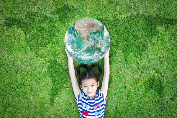 Sustainable world environment and CSR with people campaign concept with girl kid raising earth on green lawn: Element of the image furnished by NASA