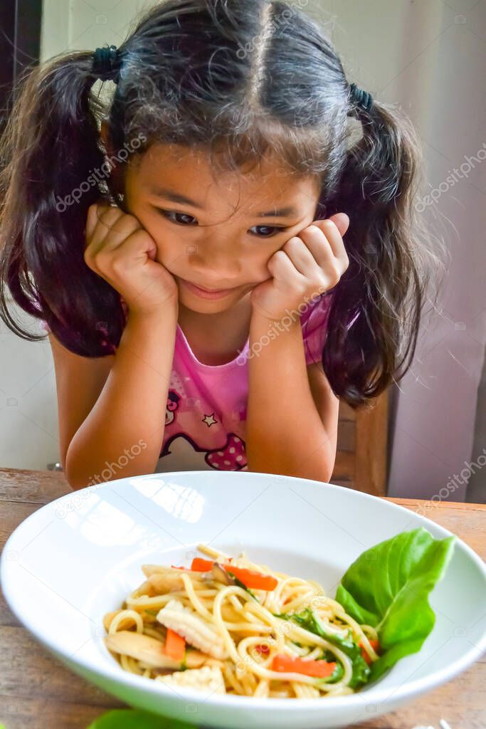 Asian kid getting bored of food refusing meal with appetite loss, no hungry eating habit 