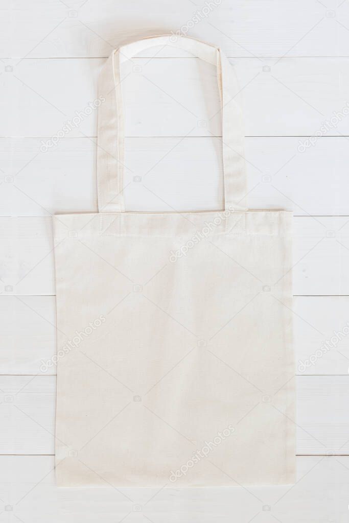 White tote bag mock up, fabric canvas cloth shopping sack template on wood table background