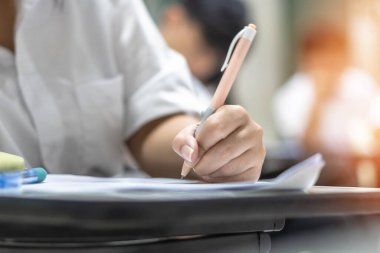 Sınavda öğrencinin sınıfta eğitim sınavına girmesi, çok düşünmesi, üniversite sınıfında cevap yazması, eğitim ve dünya okur yazarlığı konsepti.