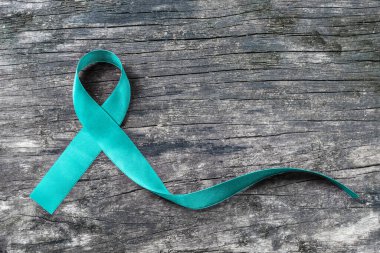 Teal ribbon awareness (isolated with clipping path) for Ovarian Cancer, Polycystic Ovarian Syndrome (PCOS) disease, Post Traumatic Stress Disorder (PTSD), Obsessive Compulsive Disorder (OCD) clipart