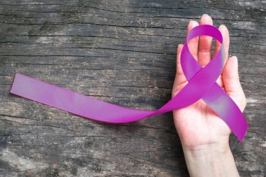 Purple plum ribbon on helping hand support for raising awareness on Alzheimer's disease, family caregivers, epilepsy for World Alzheimer's day (month) clipart