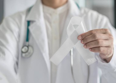 White ribbon or light pearl bow color symbolic for raising awareness on Lung cancer, bone cancer, Multiple Sclerosis, and symbol for international day of non-violence against women clipart