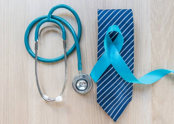 Blue ribbon symbolic of prostate cancer awareness and men's health in November month  on necktie and stethoscope