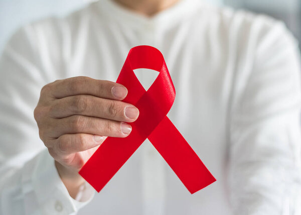 Aids red ribbon awareness for World Aids Day concept and HIV virus awareness concept 