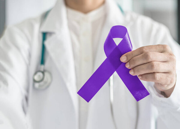 Hodgkin's lymphoma and testicular cancer awareness violet ribbon symbolic bow color on doctor's hand support 