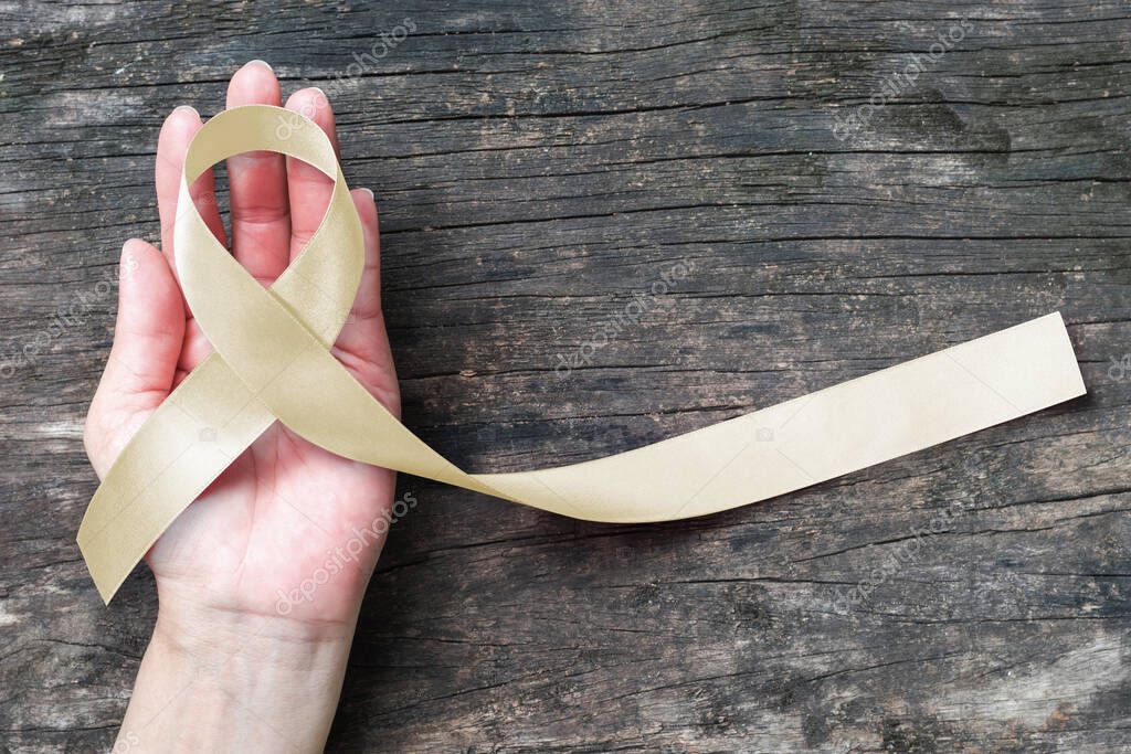 Cream awareness ribbon on helping hand support symbolic bow color for Degenerative Disc Disease (DDD), Paralysis, Spinal Cord Injuries (SCI), Spinal Disorders and Muscular Atrophy