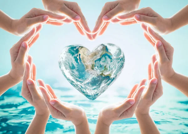 World heart day and environmental protection concept with love earth in community volunteer's hands. Element of this image furnished by NASA