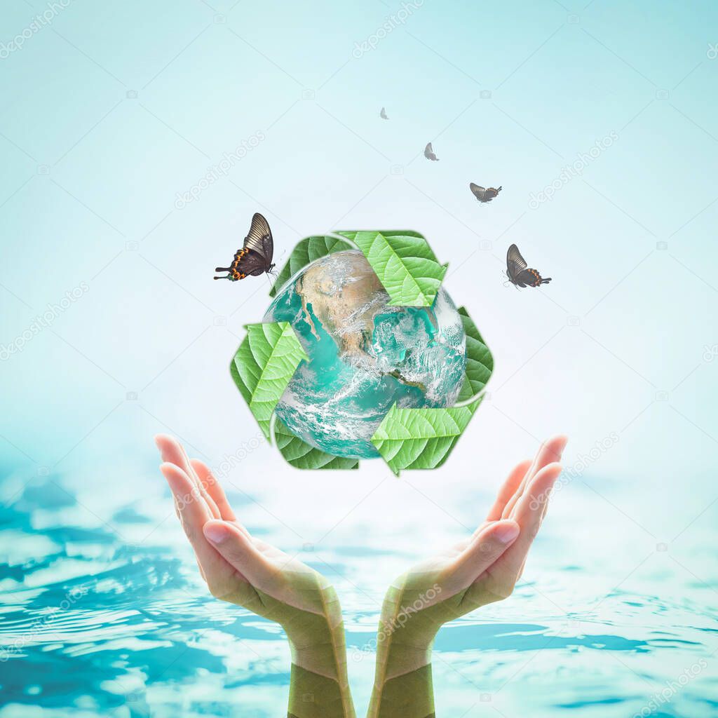 Green planet with recycle sign on hands with tree leaves for world environment day and ecological friendly concept: Elements of this image furnished by NAS