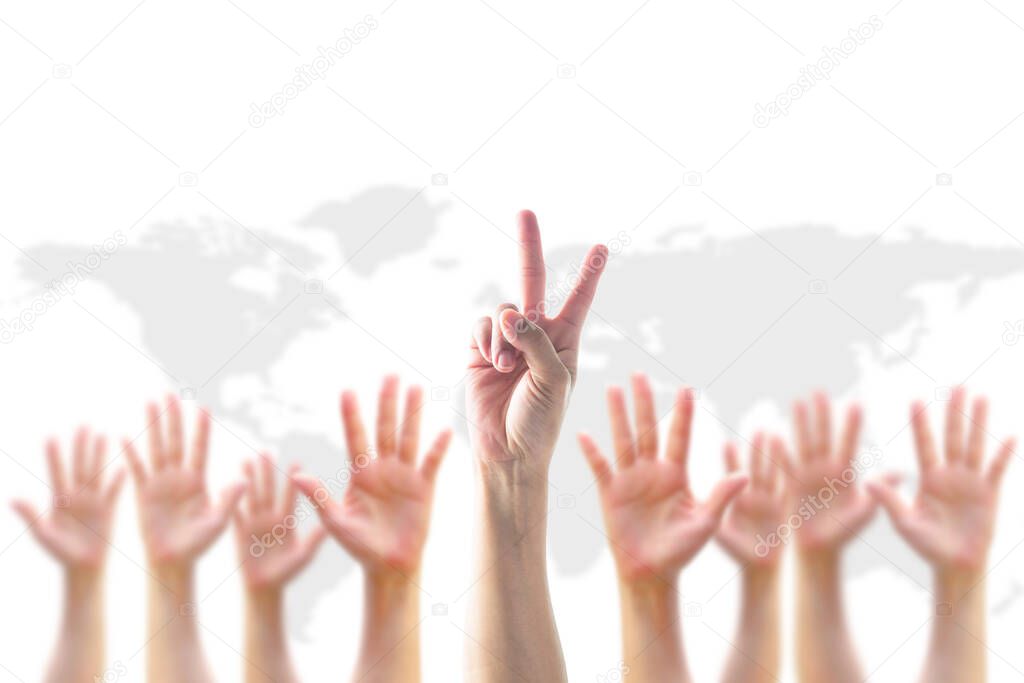 Leader's two fingers V victory sign among blur hands crowd group for World participation, leadership, volunteer concep