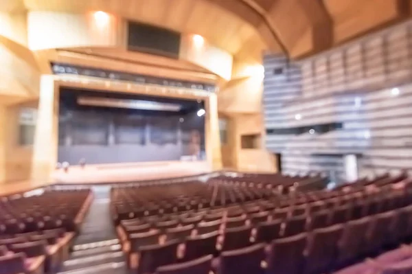 Theatre play,  opera music concert hall, performing arts entertainment show or auditorium blur background with blurry stage for drama act performance, and empty audience seat in large room interior