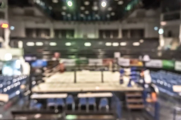 Boxing arena with box ring blur background for Muay Thai combat sport fight match battle with blurry stage and empty stadium hall for audience from top view