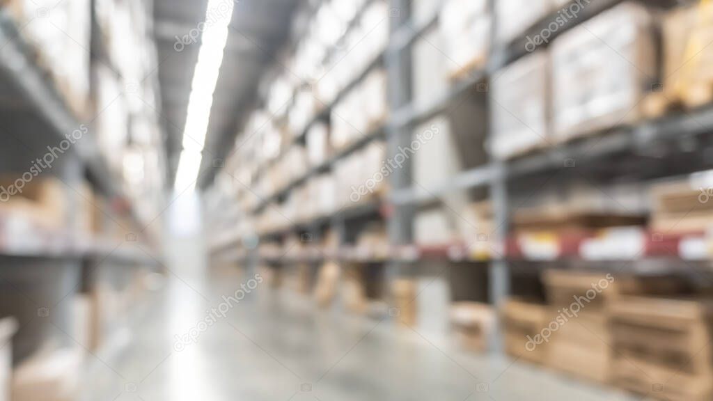 Warehouse industry blur background with  logistic wholesale storehouse, blurry industrial silo interior aisle for furniture merchandise inventory and wood material, construction supplies big box store