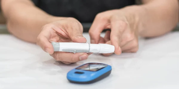 Diabetes monitoring with blood sugar test, glocuse measurement on aged woman patient fingertip for analyzing insulin-deficient illness, diabetic disease awareness and control