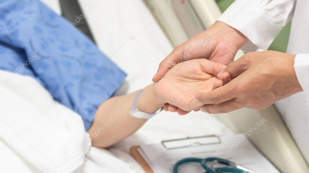 Patient on bed with doctor holding hands for nursing, medical health care, caregiver and in-patient ward healthcare concept