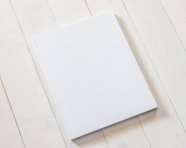 Boş kitap kapağı modelleme şablonu. Ahşap masa üzerinde beyaz yüzey üzerinde sayfa önü şablonu.
