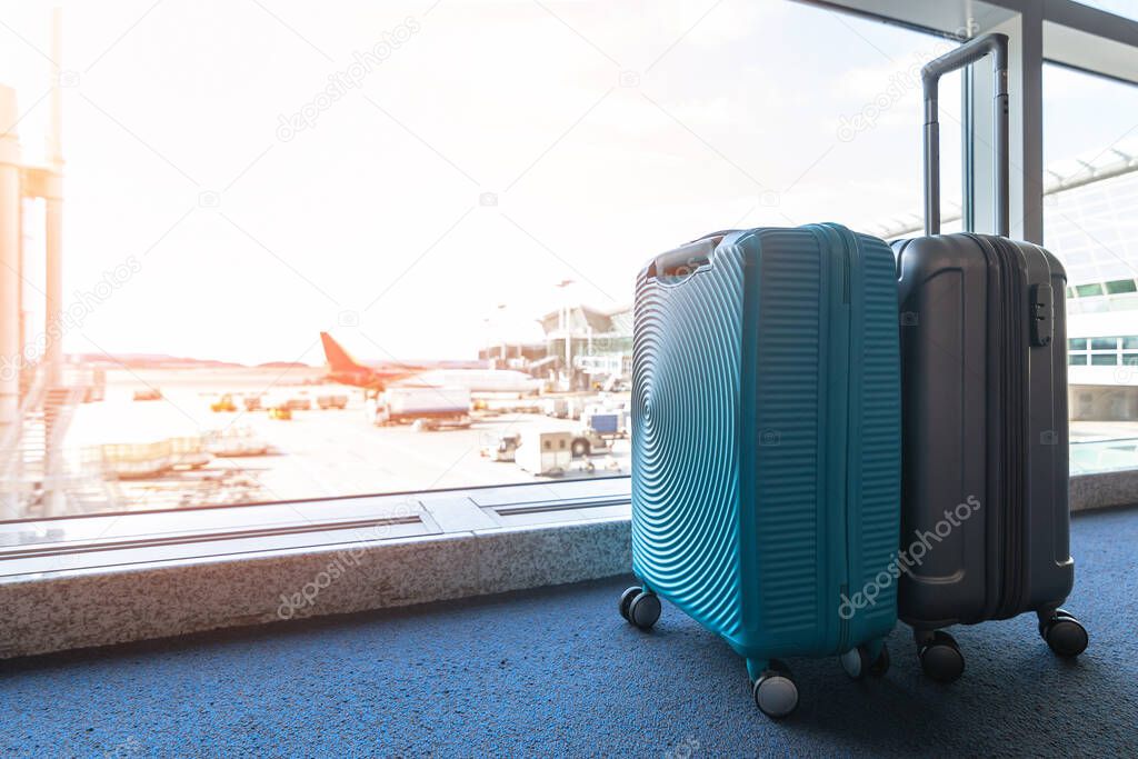 Travel luggage suitcase at the airport terminal in waiting area for departure flight for business transportation and vacation journey concept