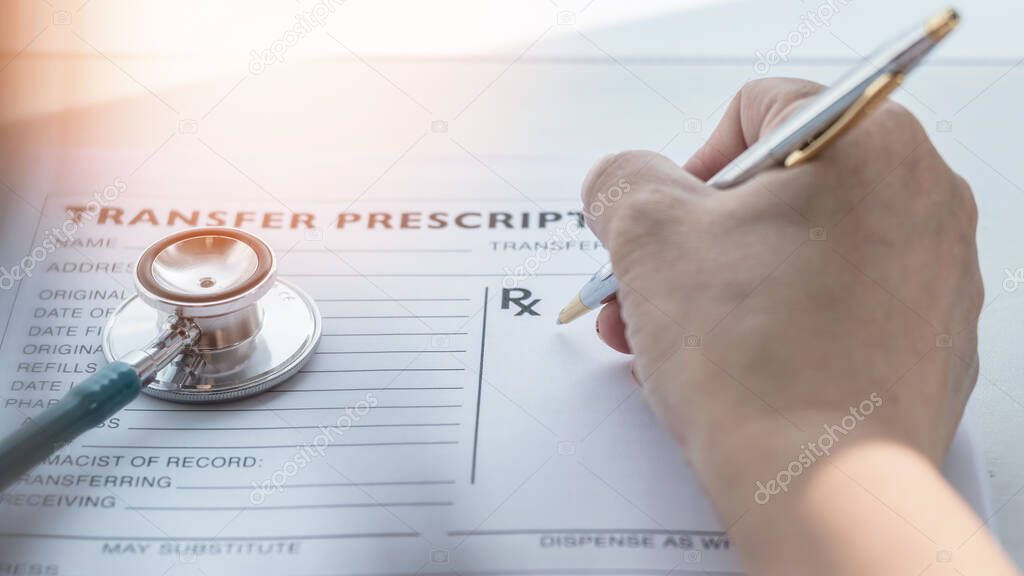 Prescription for patients medical health care record with doctor or medic pharmacist hand writing prescribing treatment in paper blank healthcare form on working desk