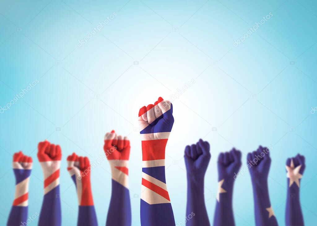 Australia labour day, Anzac day, Australian holiday concept with national flag on people fist hand raising in the air on blue sky background 