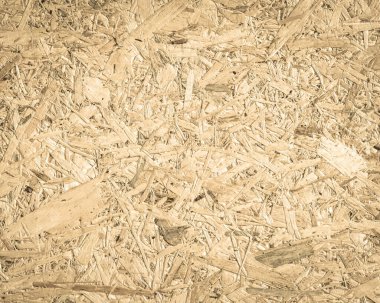 Chipboard, OSB yönelimli parçacık geri dönüştürülmüş ahşap panel arka planda kumlu ahşap fiber desen arka planda doğal yaşlanmış sepia kahverengi renkte