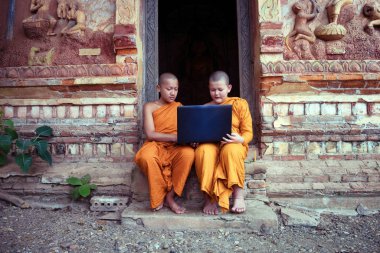 Eğitim acemi rahip Budizm dizüstü learning Nong Khai Tayland Budist kilisede oturan arkadaş grubu kullanma.
