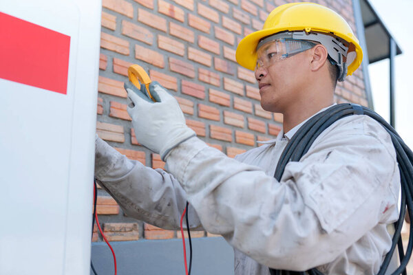 Air conditioner technician working installing the compressor air outside the building