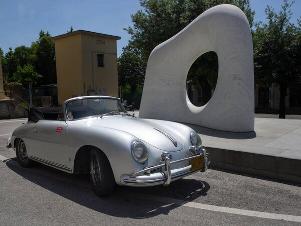 Pietrasanta  Italy _ June 03, 2018:  Porsche 356 speedster Classic Spider in front of sculpture Myomu (dream's key) by Kan Yasuda in pietrasant