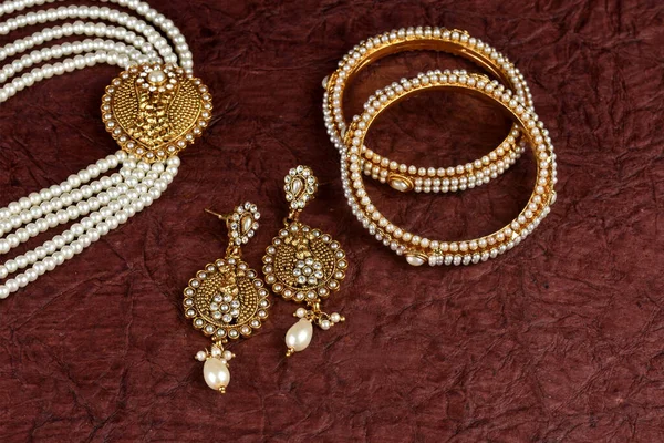 Pearl Jewelry on a textured background, Pearl bracelet, pearl necklace, pearl earrings, Style, fashion and design of jewelry. indian traditional jewellery,jewelry background