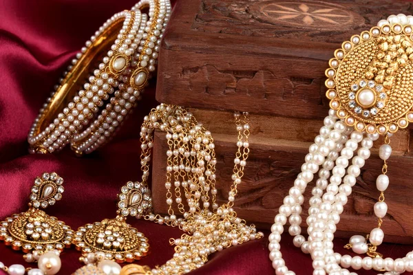 Vintage wooden jewellery box with Indian traditional jewelry, pearl earrings, pearl bracelet Luxury female jewelry, Indian traditional jewellery,Bridal Gold wedding jewellery, pearl jewelry