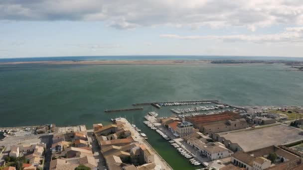Back aerial traveling over Marseillan town tabarka shellfish port sunny day — Stock Video