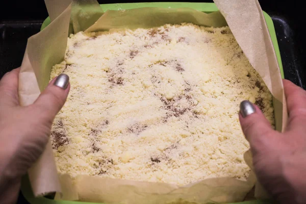 One of the stages of preparation of Apple pie. Woman hands cooking dessert