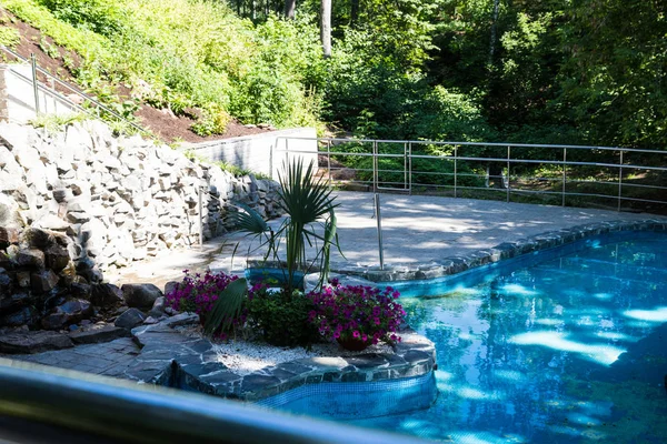 Small pool with blue water in the summer Park