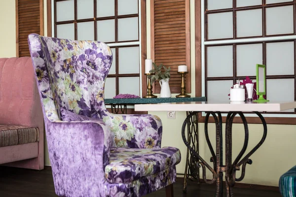 Nice colored armchair at the table in a bright room